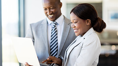 Business man and business woman working on a laptop